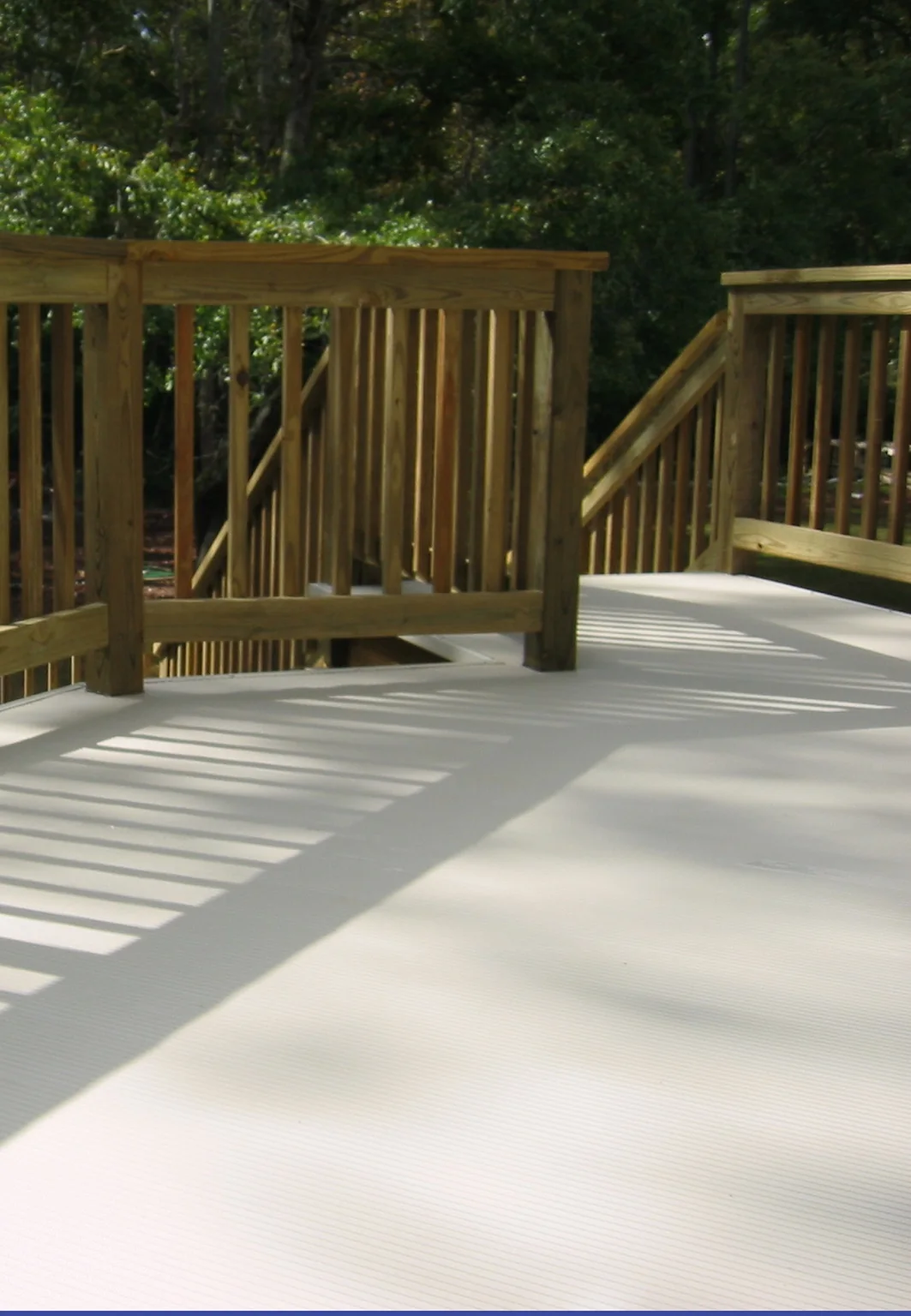 Coated or finished deck surface with railing